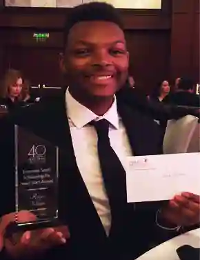 photo of Reece Wilson holding an award